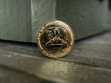 A gold-colored commemorative medallion, showcasing a design of the King Tiger V2 tank with The Tank Museum logo on the edges
