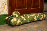 A long draught excluder shaped as a TOG II tank with a camouflage print.
