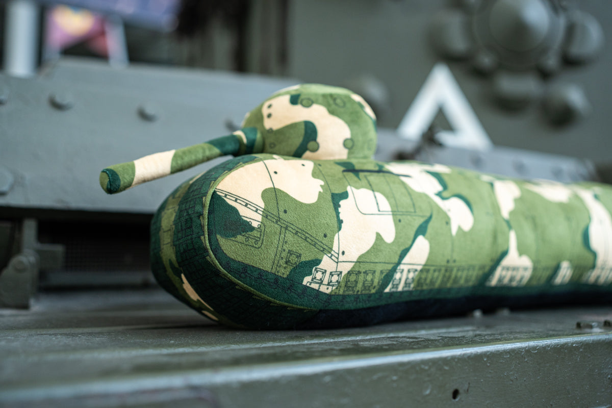 A long draught excluder shaped as a TOG II tank with a camouflage print.