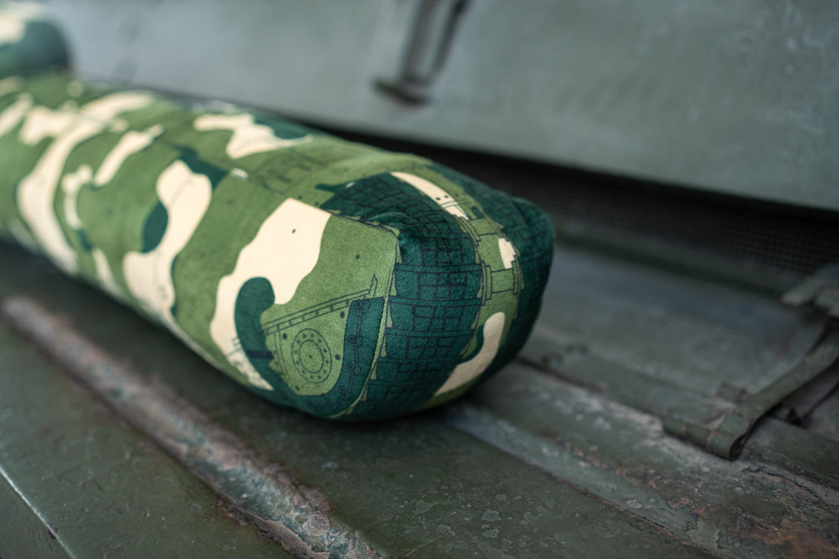 A long draught excluder shaped as a TOG II tank with a camouflage print.