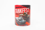 A cylindrical mug featuring a 'World of Tanks' Tankfest graphic print with red and black background, white text, and tank illustrations, shown on a plain white background.