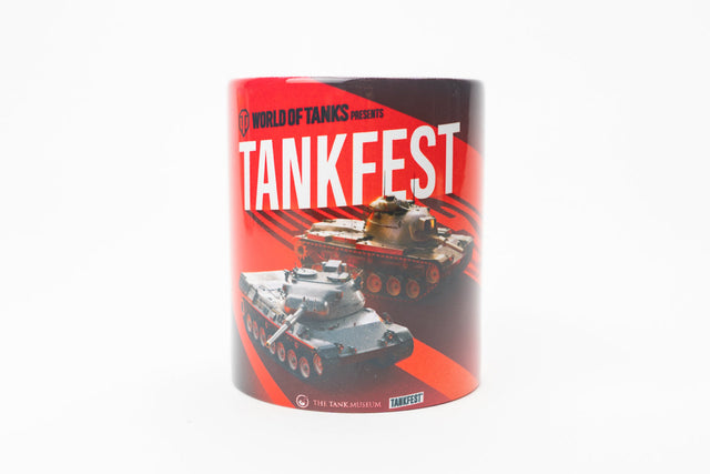 A cylindrical mug featuring a 'World of Tanks' Tankfest graphic print with red and black background, white text, and tank illustrations, shown on a plain white background.